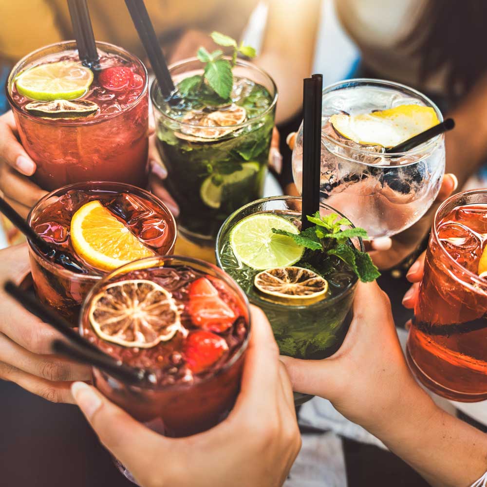 Many colorful cocktails in close up that toast